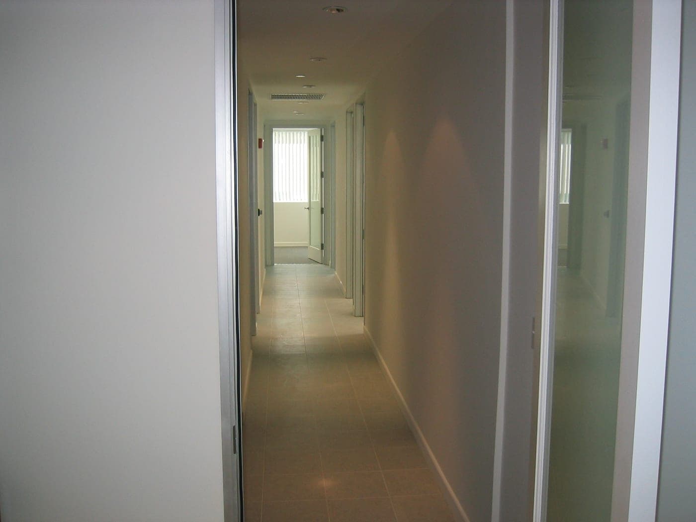 The central corridor of the Beverly Hills medical office with its aluminum-framed glass entry