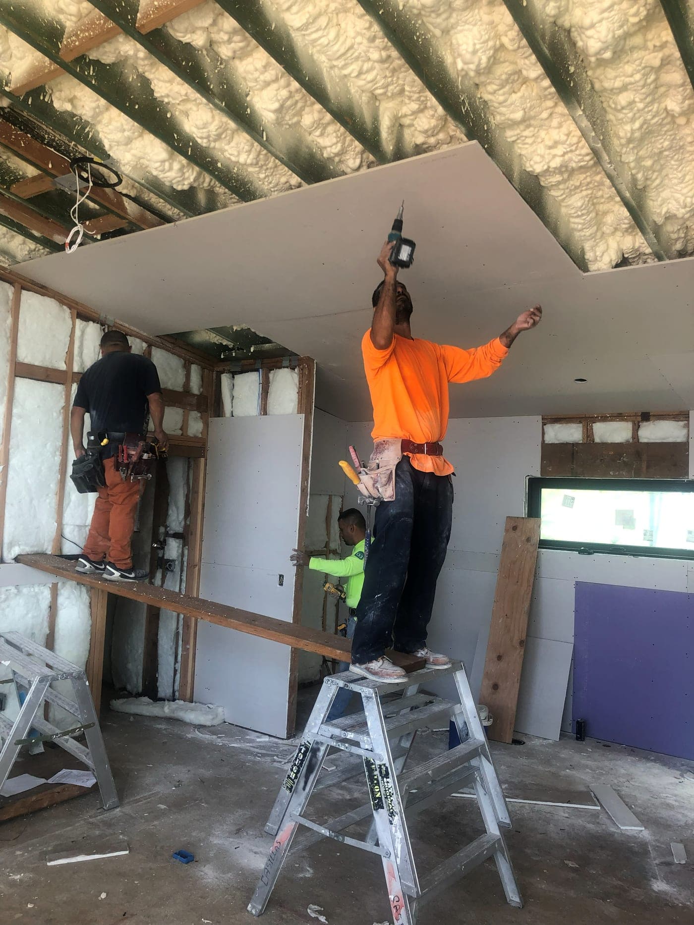 Insulation in the ceiling and drywall being installed inside the Malibu home