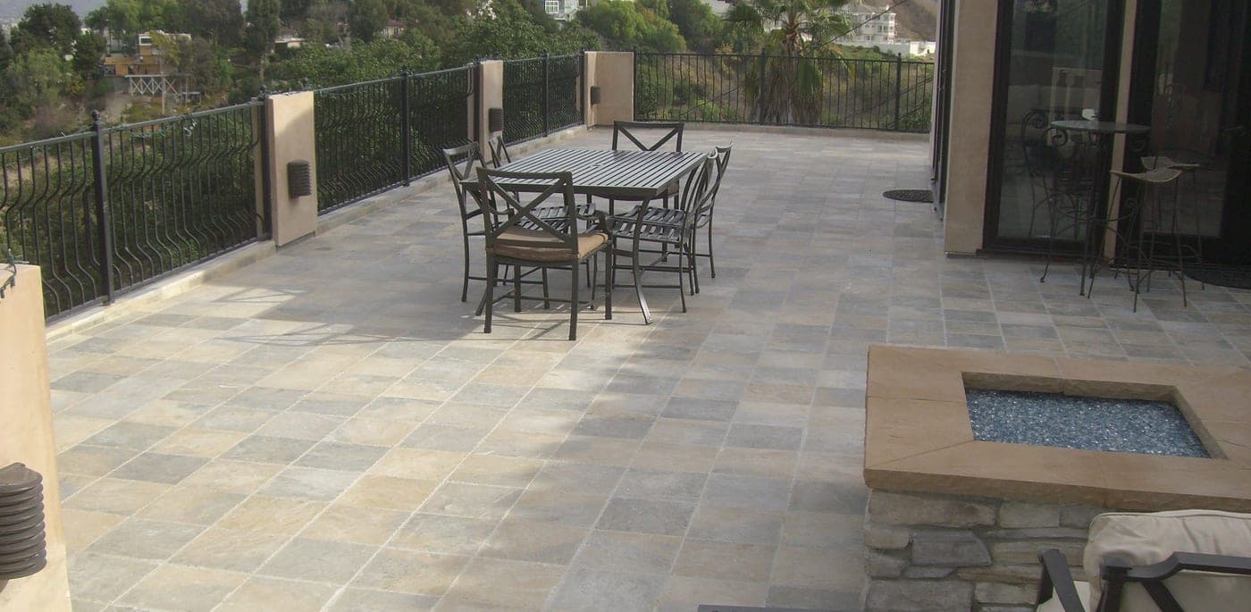 The finished Studio City deck with fresh stone tile and a custom stone gas firepit overlooking the hills