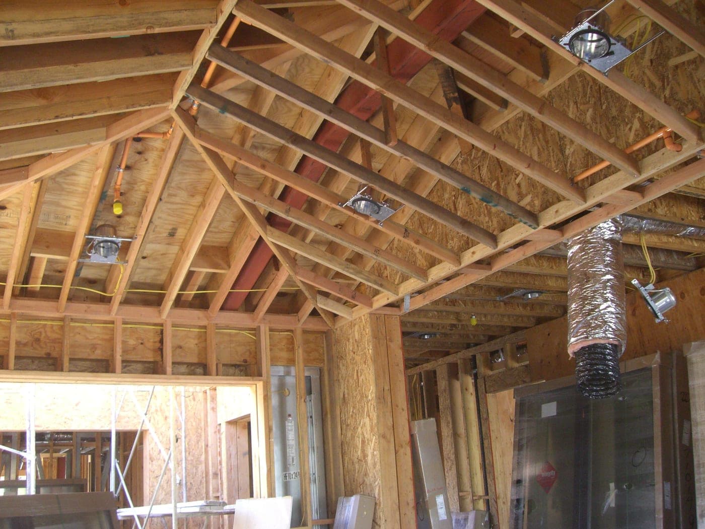 Ductwork and rough-in systems installed within the open framing of a new home in West Los Angeles